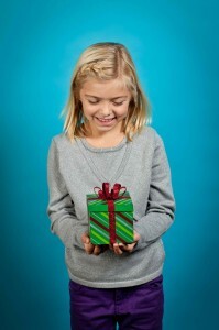 Kozzi-girl-looks-down-at-gift-1183 X 1774